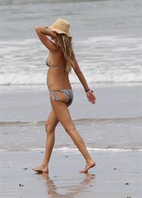 A pregnant Gisele Bundchen walking on the beach in Costa Rica - July 23, 2012.  She is pregnant with her second child