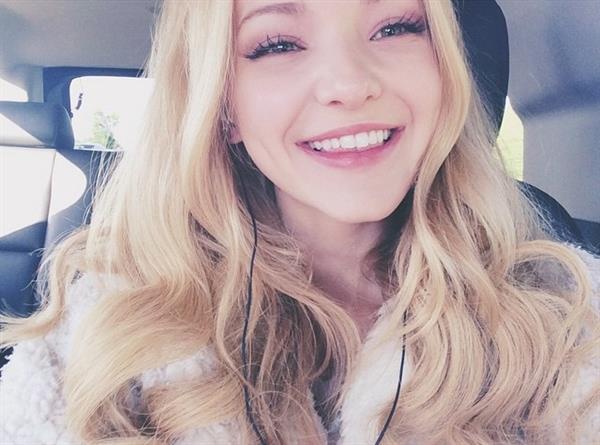 Dove Cameron taking a selfie