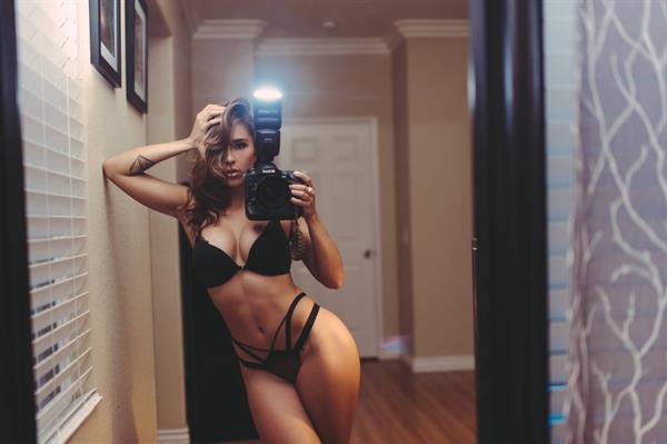 Tianna Gregory in a bikini taking a selfie