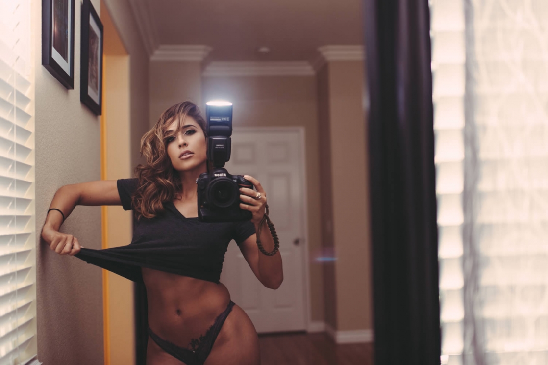 Tianna Gregory in a bikini taking a selfie