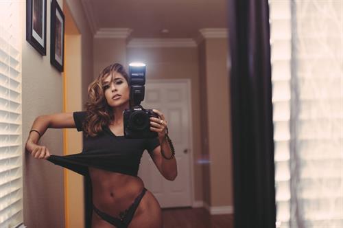 Tianna Gregory in a bikini taking a selfie