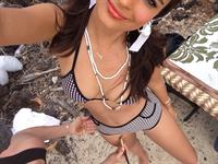 Emily Ratajkowski in a bikini taking a selfie