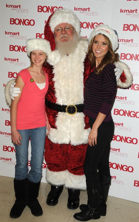 Audrina Patridge poses with Santa Claus