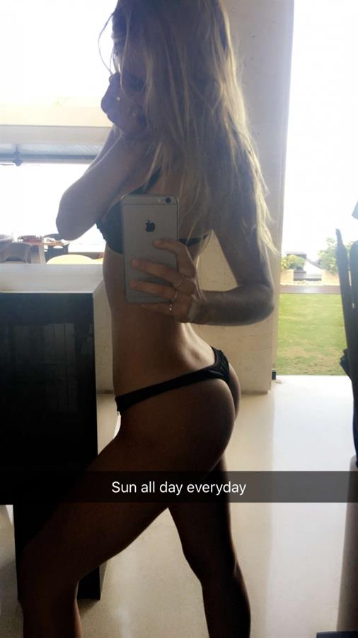 Alexis Ren in a bikini taking a selfie