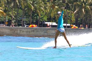 Alessandra Ambrosio surfing and eating a sno cone in Hawaii on October 12, 2011 