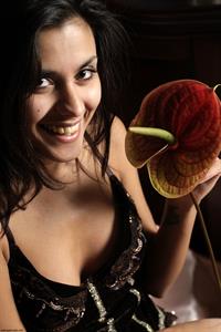 Belinda A nude poses with a flower