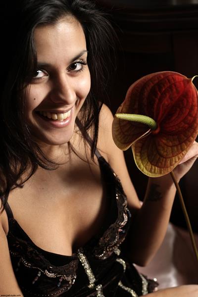 Belinda A nude poses with a flower