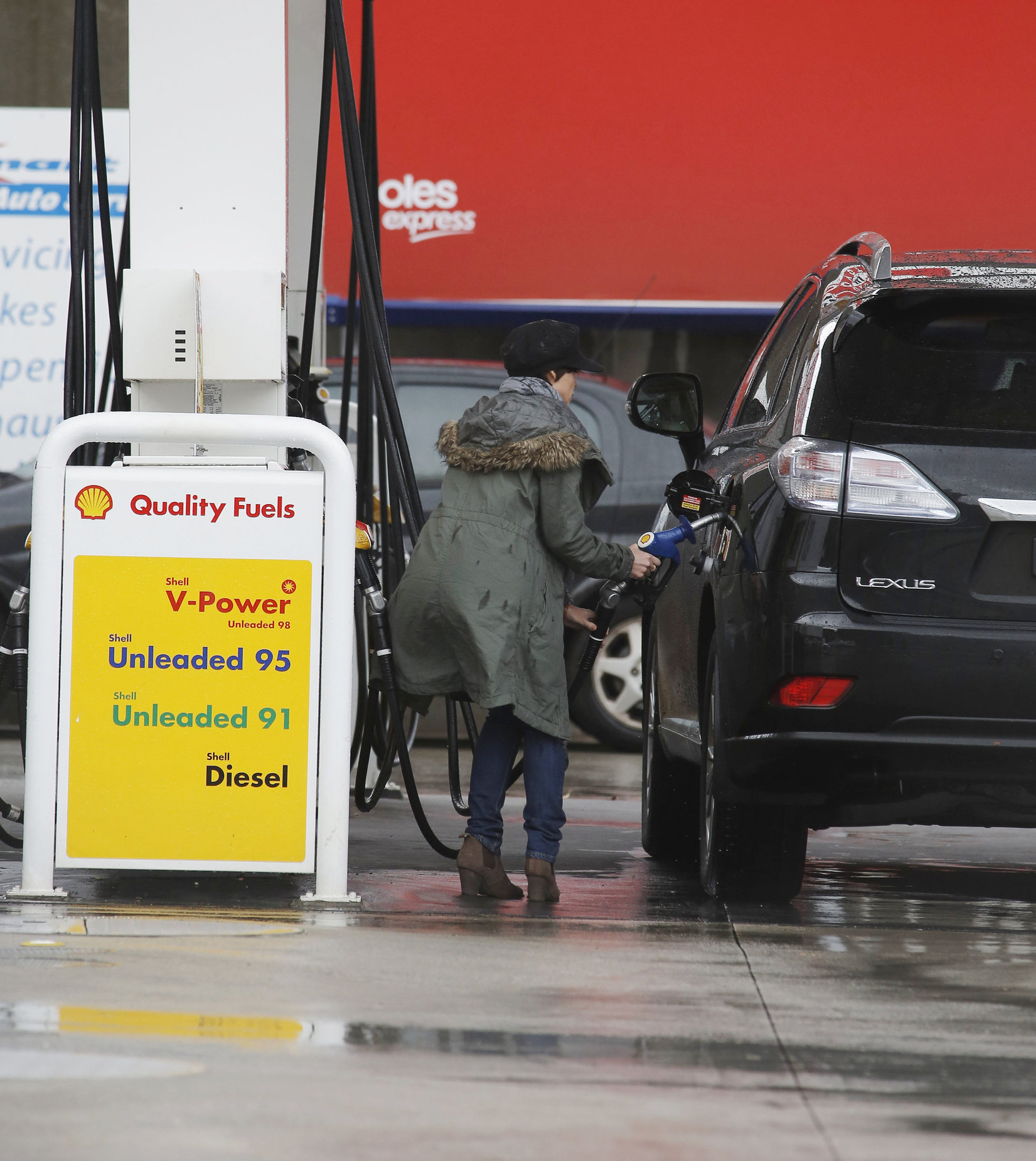 Dannii Minogue - Pictured getting a little wet while filling up on petrol - 09th August 2012