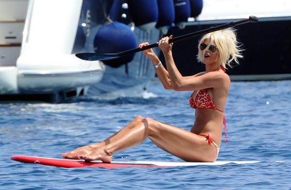 Victoria Silvstedt wearing a bikini on a board in Sardinia on August 8, 2012