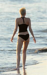 Miley Cyrus  yoga in black bikini on beach in Hawaii 1/24/13 