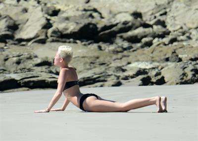 Miley Cyrus  yoga in black bikini on beach in Hawaii 1/24/13 