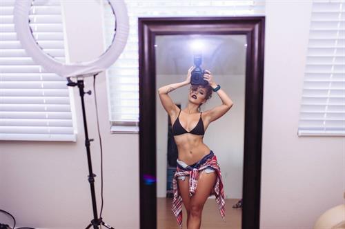 Tianna Gregory in a bikini taking a selfie