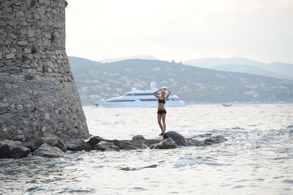 Kimberley Garner in a black bikini on the beach in St. Tropez on July 31, 2014