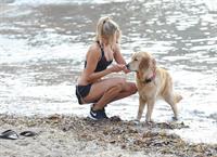 Kimberley Garner in a black bikini on the beach in St. Tropez on July 31, 2014