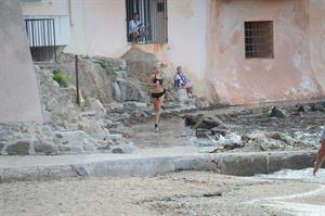 Kimberley Garner in a black bikini on the beach in St. Tropez on July 31, 2014