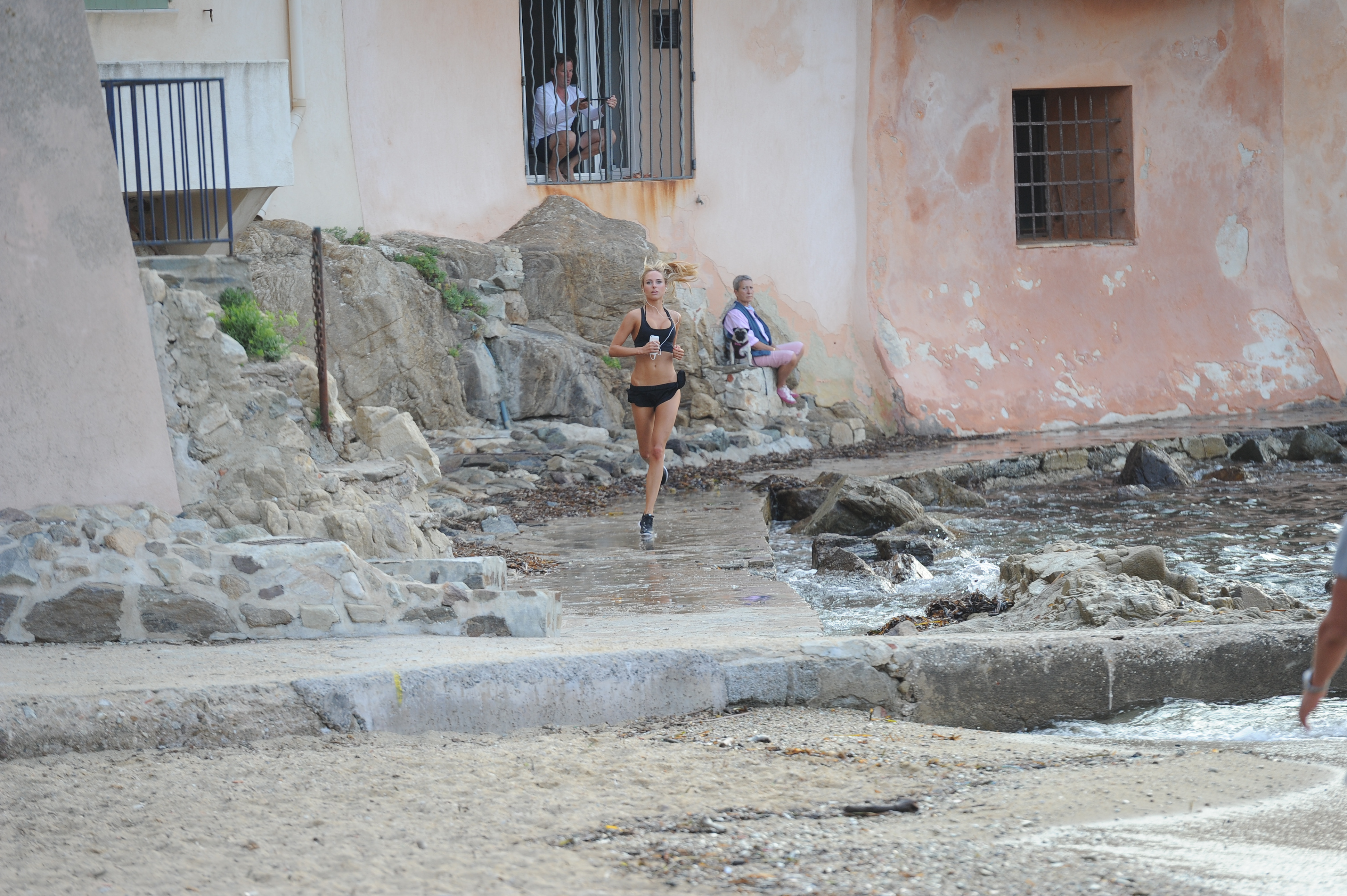 Kimberley Garner in a black bikini on the beach in St. Tropez on July 31, 2014