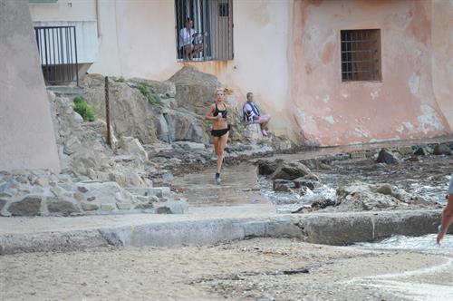 Kimberley Garner in a black bikini on the beach in St. Tropez on July 31, 2014