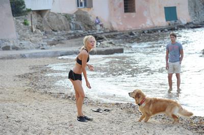 Kimberley Garner in a black bikini on the beach in St. Tropez on July 31, 2014