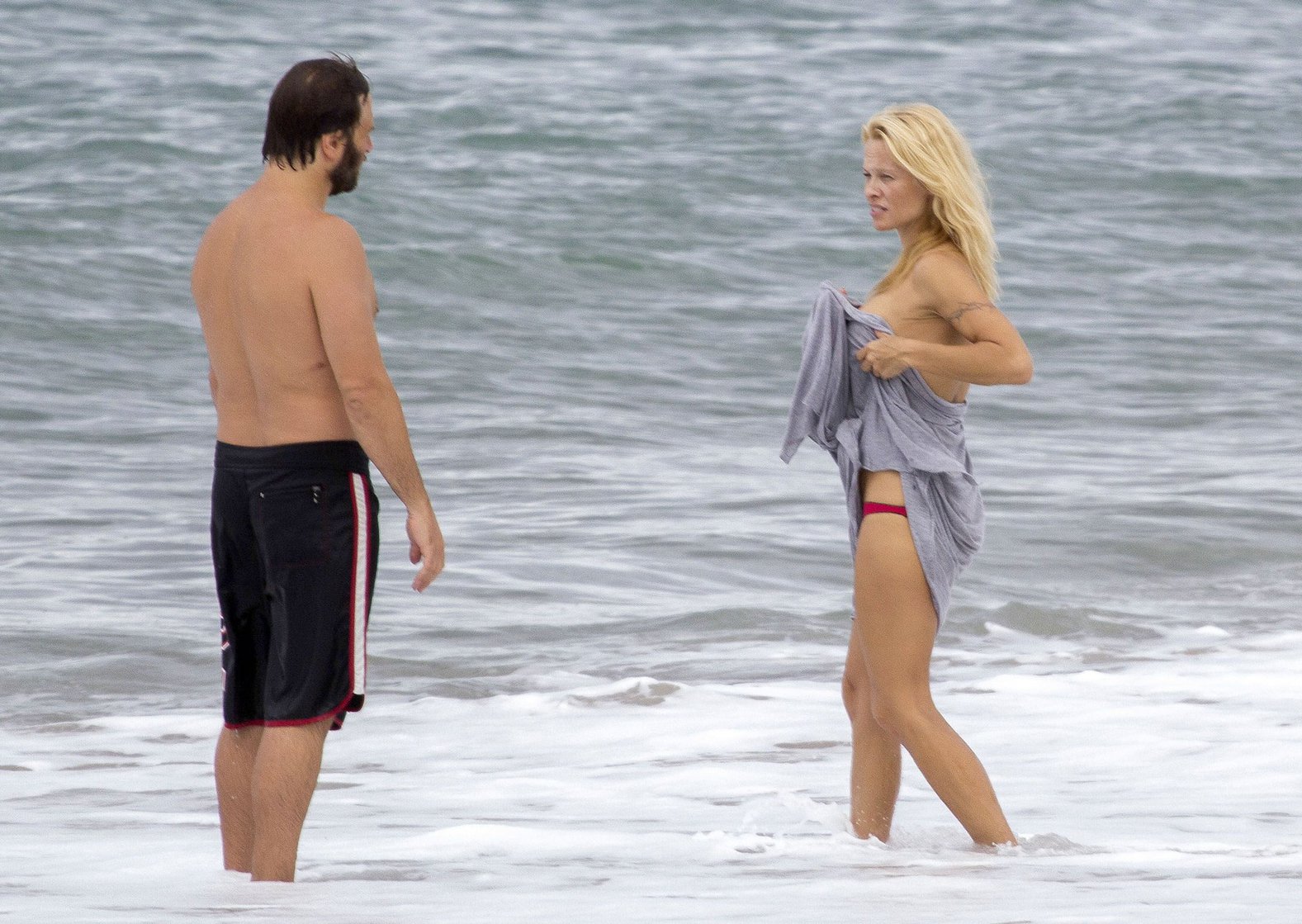 Pamela Anderson Pamela Anderson Going topless at the beach in France 02.10.13
