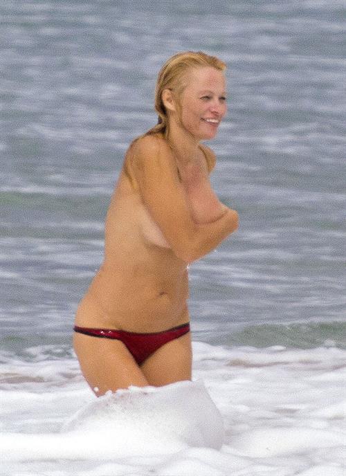 Pamela Anderson Pamela Anderson Going topless at the beach in France 02.10.13