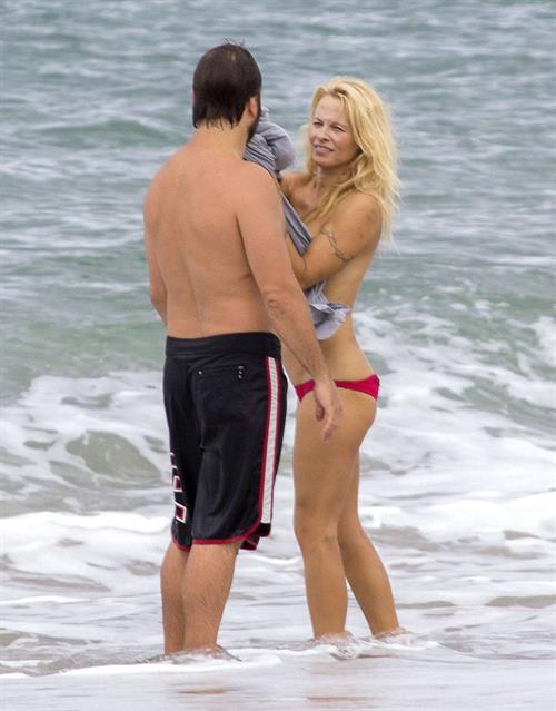 Pamela Anderson Pamela Anderson Going topless at the beach in France 02.10.13