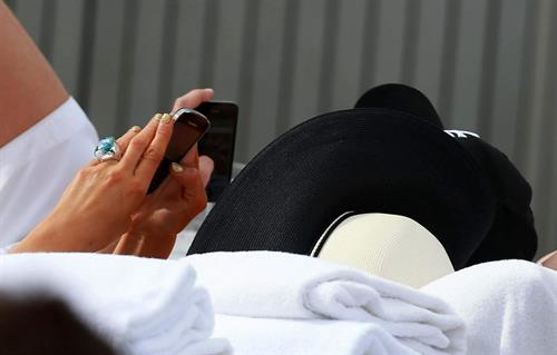 Paris Hilton spends the day in and out of the pool in Miami December 8, 2012