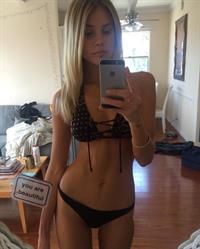 Allie Leggett in a bikini taking a selfie