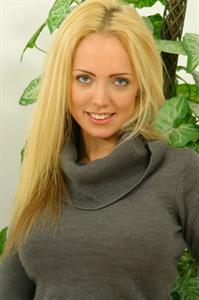 Aisleyne Wallace in a grey dress and red lingerie