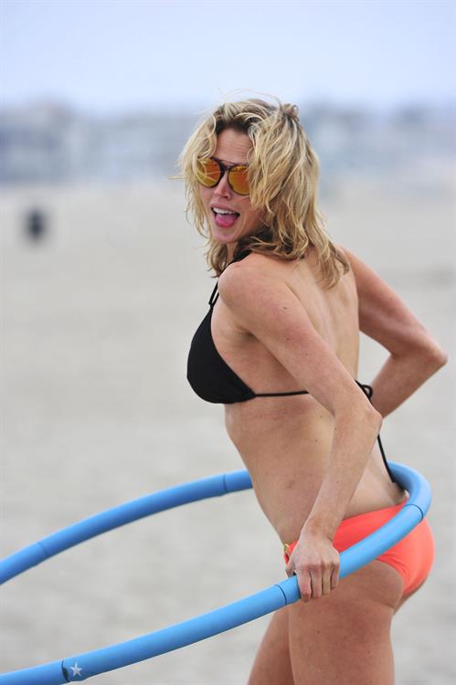 Estella Warren in a bikini with a hula hoop in Venice Beach on August 12, 2014
