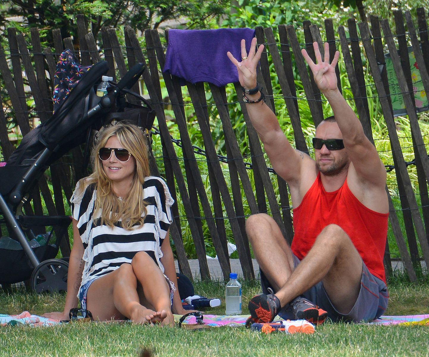Heidi Klum in a black and white striped shirt, spends a day out in a park in Tribeca on June 30, 2013 