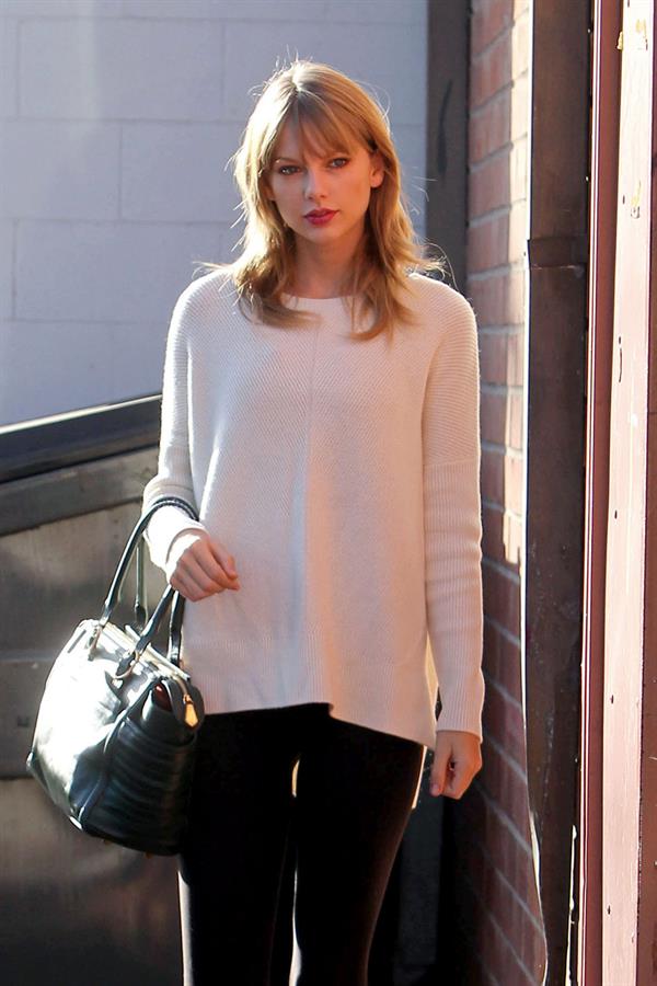 Taylor Swift wearing a white top and black pants in Los Angeles 10/28/13  