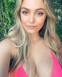 Raine Michaels in a bikini taking a selfie