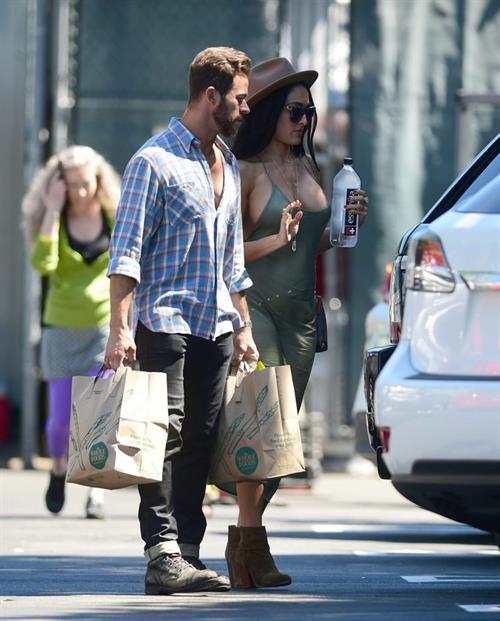 Nikki Bella Pictures Nikki Bella braless boobs in a green dress seen by paparazzi.