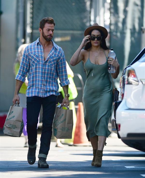 Nikki Bella braless boobs in a green dress seen by paparazzi.
















