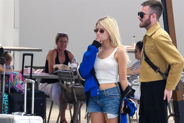Lottie Moss braless boobs in a white top seen by paparazzi at the airport.

