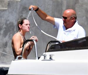 Kristen Stewart nude boobs caught topless by paparazzi tanning on a boat.
