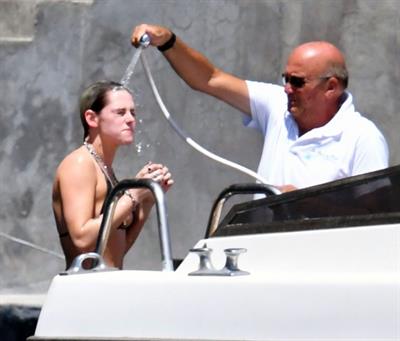 Kristen Stewart nude boobs caught topless by paparazzi tanning on a boat.
