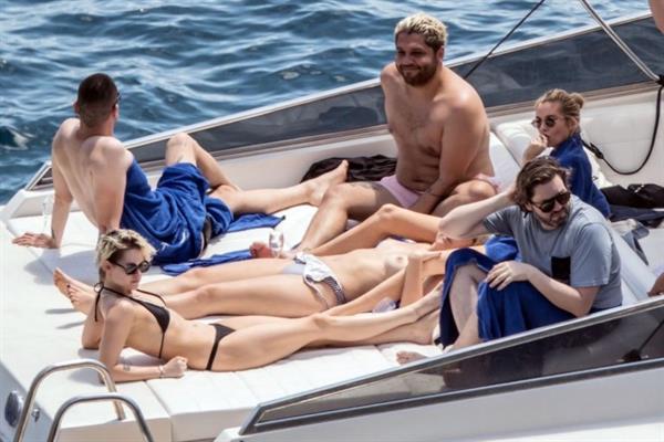 Kristen Stewart nude boobs caught topless by paparazzi tanning on a boat.
