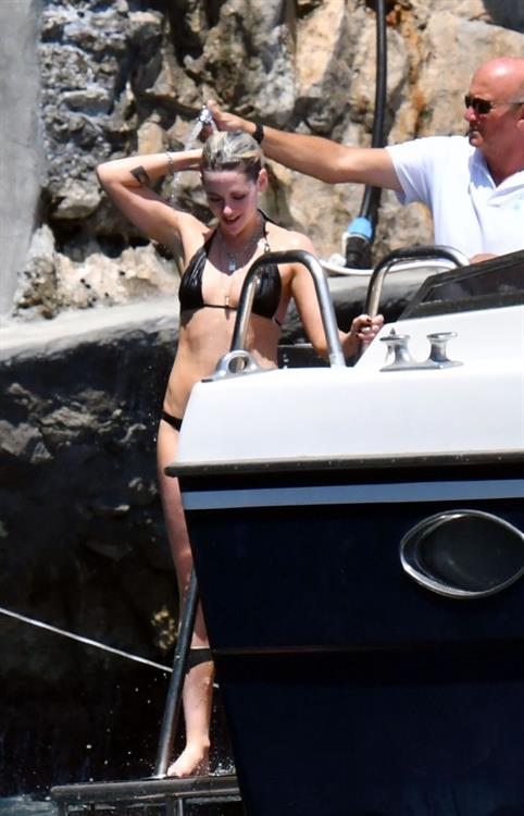 Kristen Stewart Bikini Pictures Kristen Stewart nude boobs caught topless by paparazzi tanning on a boat.