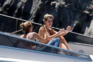 Kristen Stewart nude boobs caught topless by paparazzi tanning on a boat.
