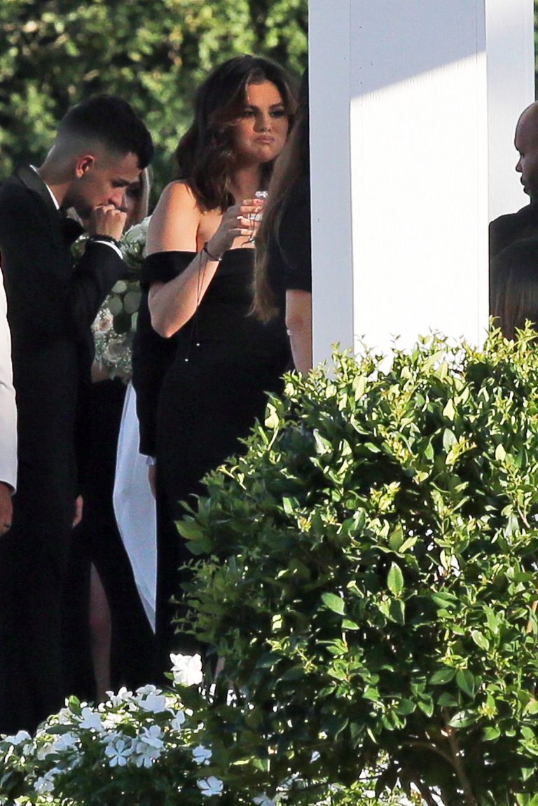 Selena Gomez Pictures Selena Gomez sexy in a black dress for her cousins wedding showing nice cleavage seen by paparazzi.