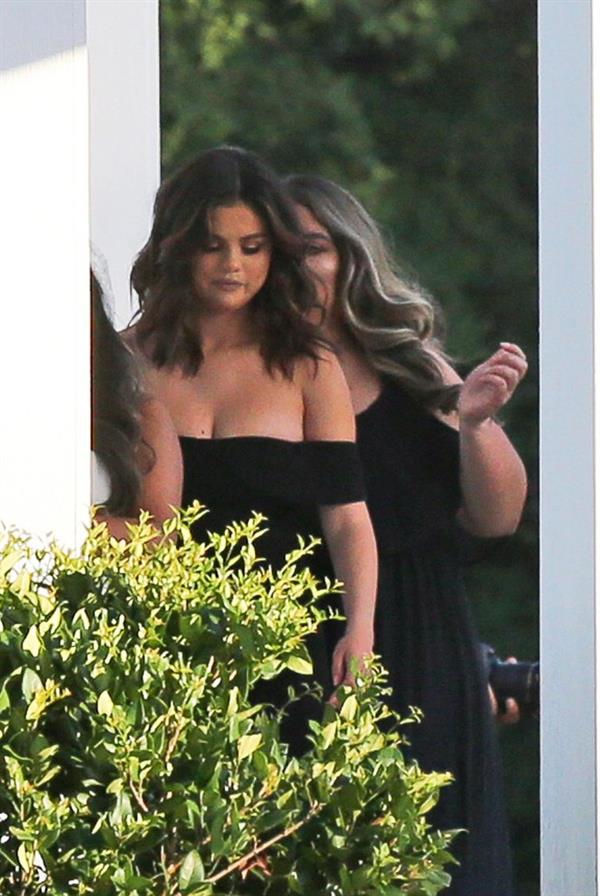 Selena Gomez sexy in a black dress for her cousins wedding showing nice cleavage seen by paparazzi.























