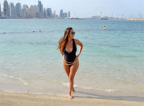 Chloe Goodman Bikini Pictures Chloe Goodman big boobs showing nice cleavage in a low cut swimsuit at the beach seen by paparazzi.