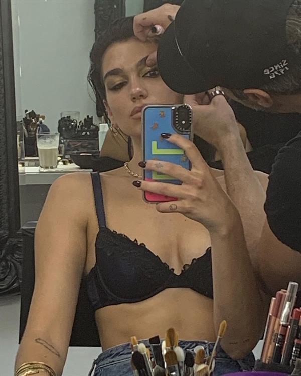 Dua Lipa sexy selfie in just a black bra showing some cleavage.












