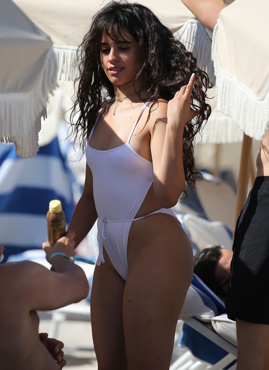 Camila Cabello Bikini Pictures Camila Cabello sexy tits and ass in a wet white swimsuit showing her nipples seen by paparazzi.