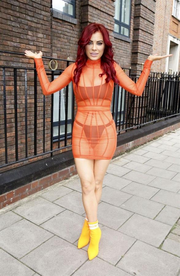 Carla Howe sexy body in a see through orange dress showing her bra and thong panties seen by paparazzi.




