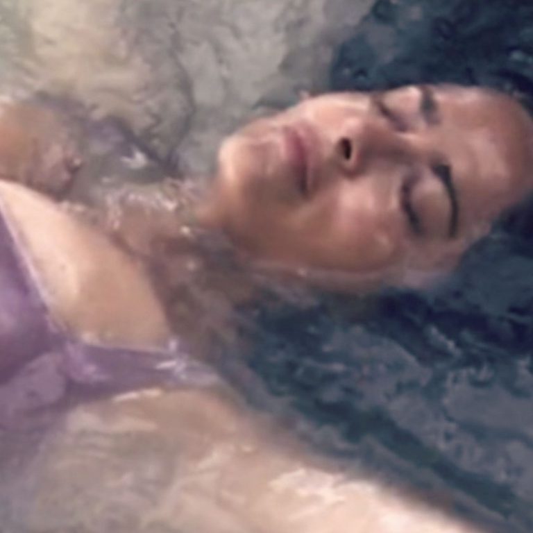 Salma Hayek Pictures Salma Hayek big boobs showing nice cleavage wet in a swimsuit laying on the beach.