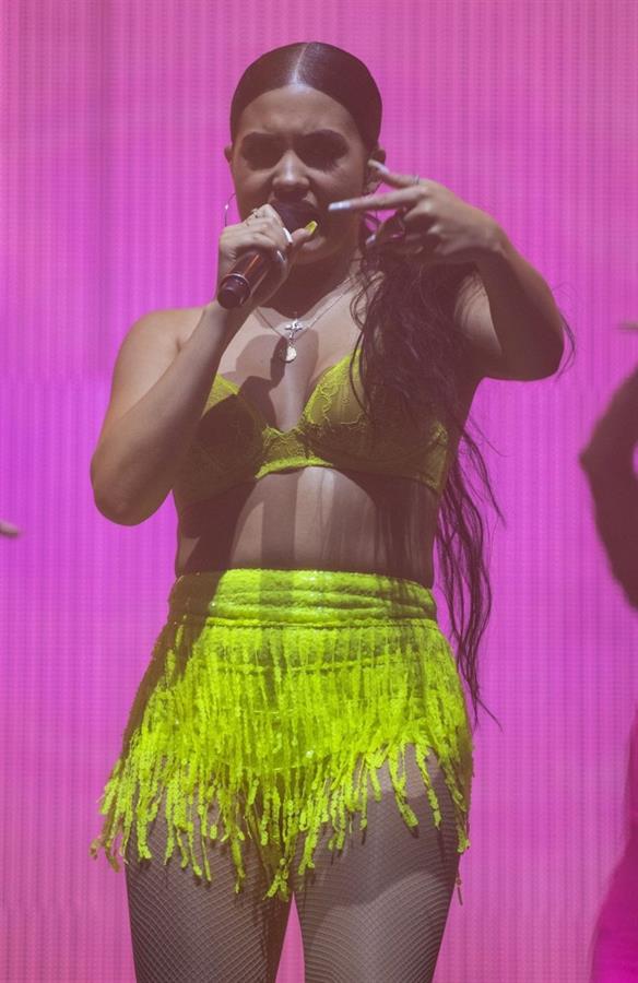 Mabel performing on stage singing in just a bra top showing off her boobs.
















