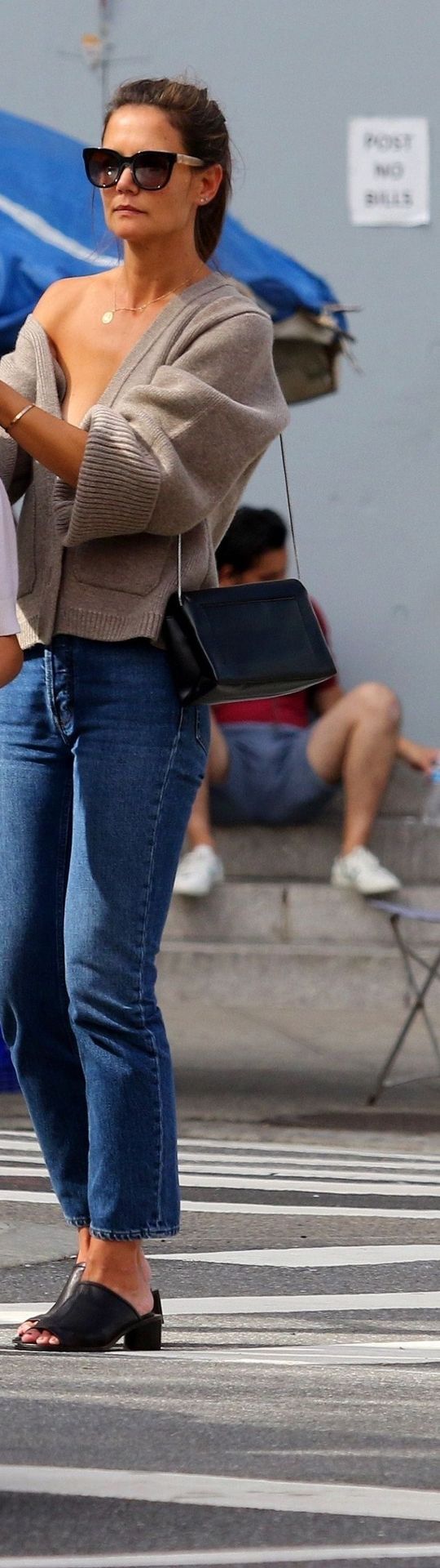 Katie Holmes Pictures Katie Holmes sexy cleavage seen by paparazzi in a revealing outfit.