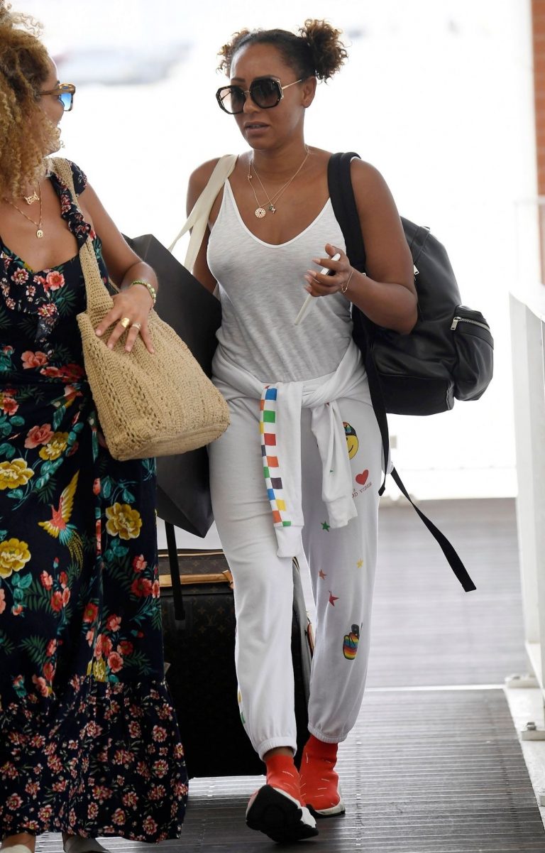 Mel B braless boobs in a see through white top showing off her tits seen by paparazzi at the airport.






